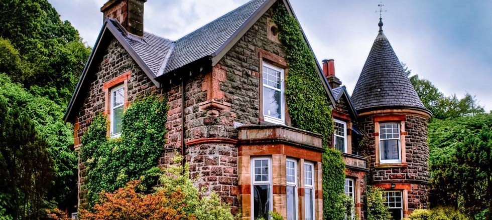 old baronial style home covered in ivy edit